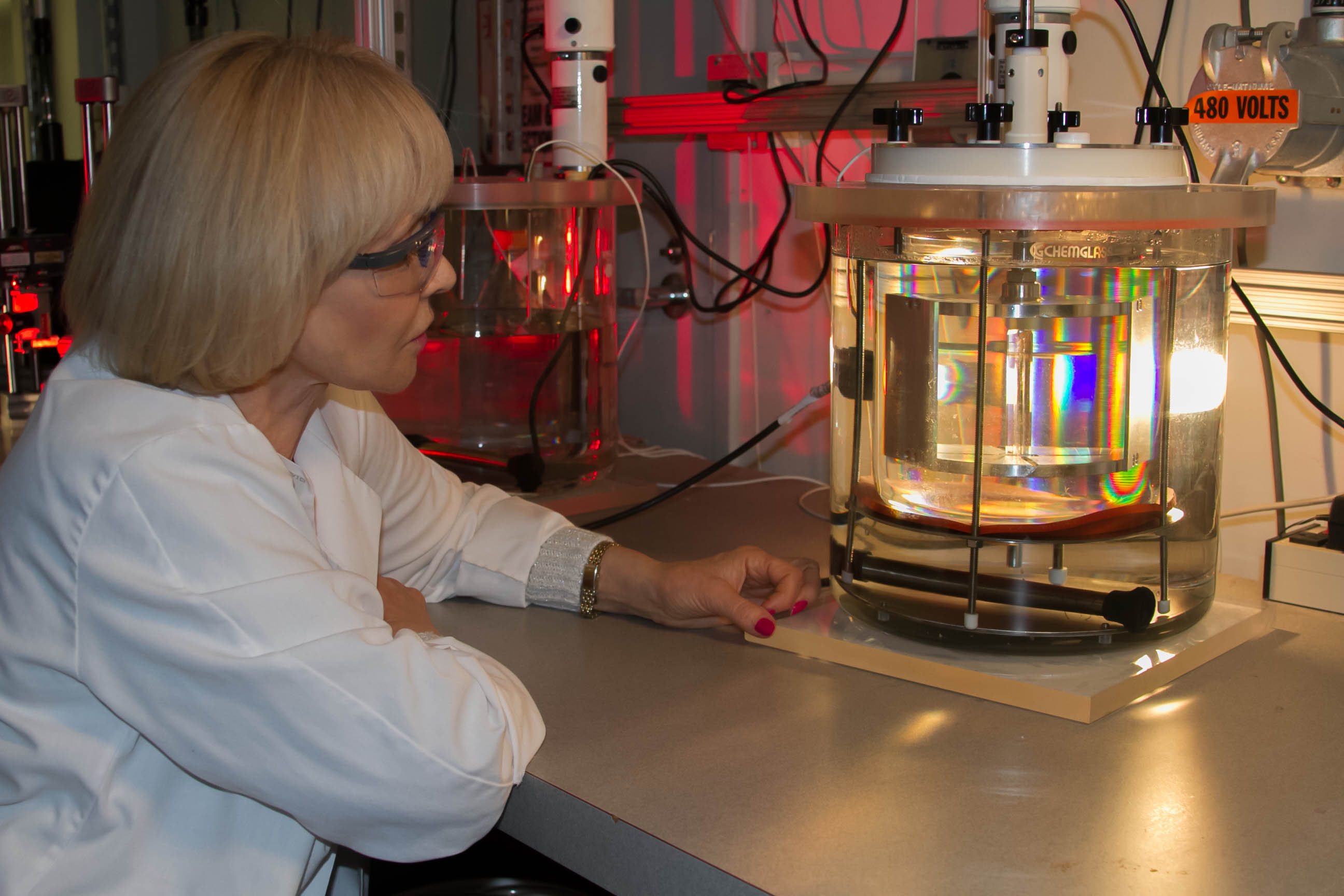 Natalia Zaitseva examines a single crystal growing in a solution-growth crystallizer developed for production of stilbene crystals for fast neutron detection