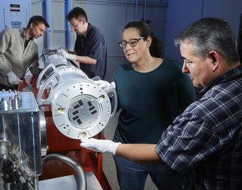 Workers Make Adjustments in FIDDLE Diagnostic Peter Nyholm, Andrew Sharp, Robin Benedetti, and Brandon Morioka (from left) make adjustments in the FIDDLE diagnostic, which can produce multiple images of phase transitions in materials over a few nanoseconds.