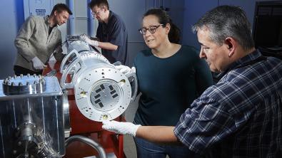 Workers Make Adjustments in FIDDLE Diagnostic Peter Nyholm, Andrew Sharp, Robin Benedetti, and Brandon Morioka (from left) make adjustments in the FIDDLE diagnostic, which can produce multiple images of phase transitions in materials over a few nanoseconds.