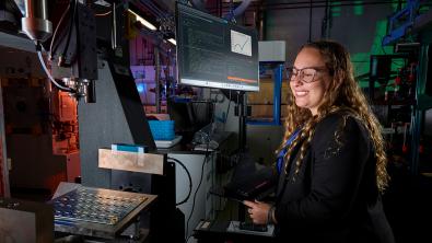 LLNL scientist Johanna Schwartz supervising the Laboratory’s Studying-Polymers-On a-Chip (SPOC) technology, which will screen potential materials for use in recyclable, polymer-based batteries. (Photo: Garry McLeod/LLNL)