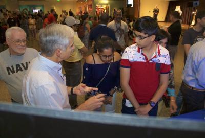 Dr. Steve Azevedo explaining Lawrence Livermore National Laboratory's technologies to museumgoers during Military Invention Day
