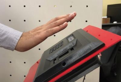 Hand above contactless biometric scanner