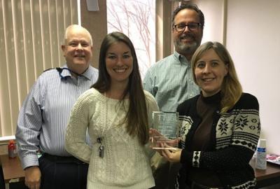 Rich Rankin (top row, left), the head of the Lab’s Innovation and Partnerships Office, presented a national technology transfer award to two business development executives – Candice Gellner (front row, left) and Charity Follet (front row, right) – and to Quentin Vaughan, an assistant general counsel in the Office of General Counsel.