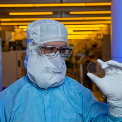 Standing in LLNL’s Center for Micro Nano Technology, Nathan Ray holds a marvel of optical engineering, a 5-centimeter metasurface optic 